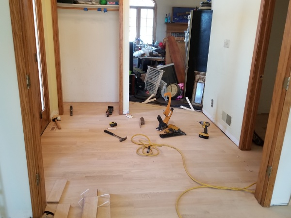 Authentic Hardwood Contractors Work to Finish A Wood Dining Room Floor